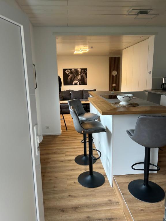 a kitchen and living room with two chairs and a table at bei gitta in Olpe