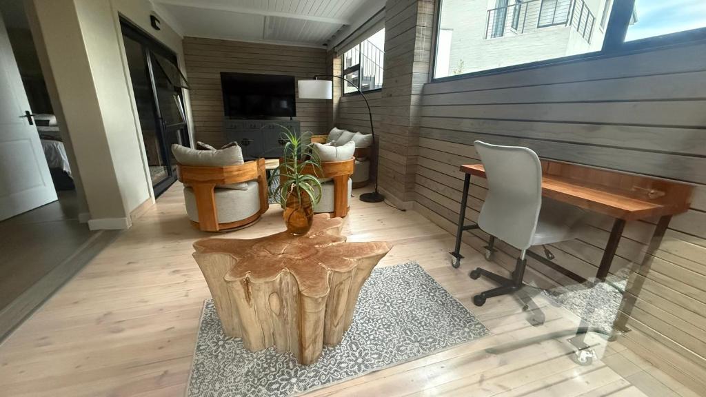 a room with a desk and a table and a chair at Shade & Salt in Sedgefield