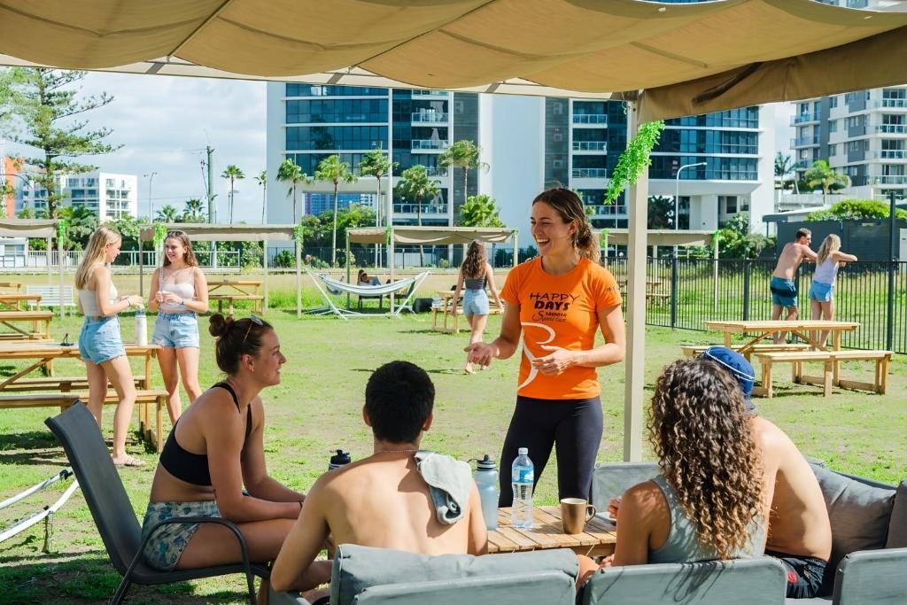 a woman talking to a group of people under a tent at Tequila Sunrise Podstel in Gold Coast