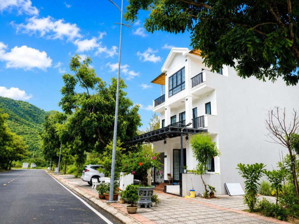 a white building on the side of a street at COBI’s Home in Cam Lâm