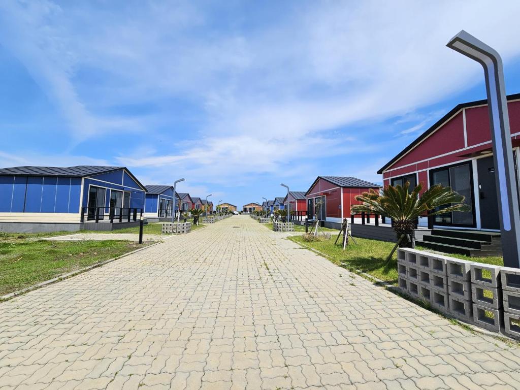 a cobblestone street in front of a row of houses at Udo Chano Village in Jeju