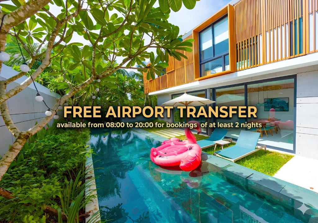 a pink inflatable boat in a swimming pool next to a house at Sailing Pool Villas & Resort Phu Quoc in Phú Quốc