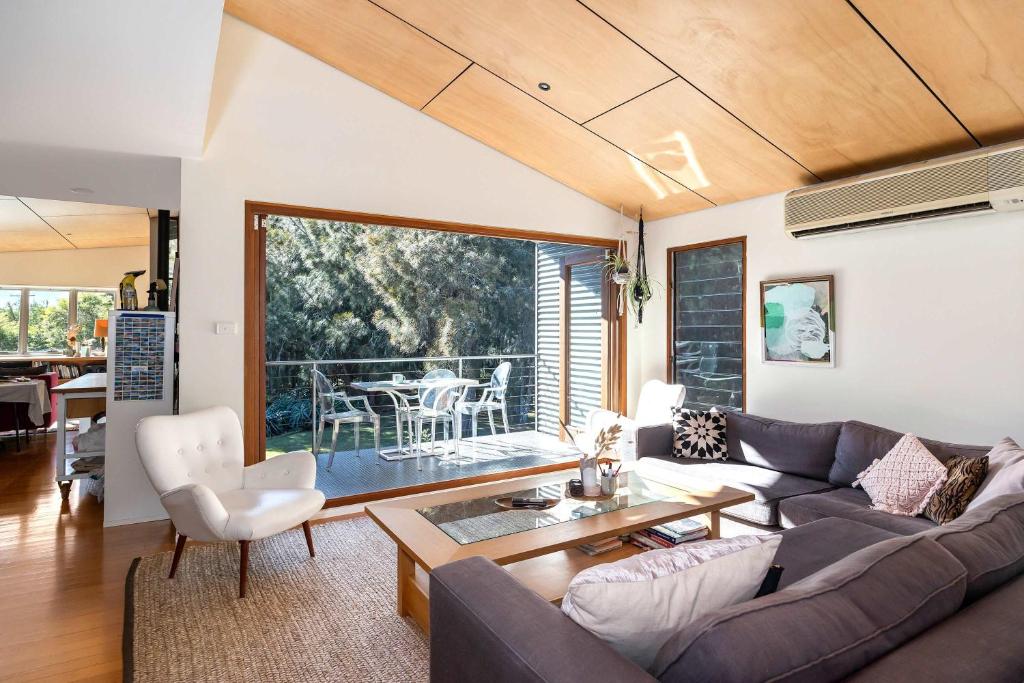 a living room with a couch and a table at Murramarang Haven in Bawley Point