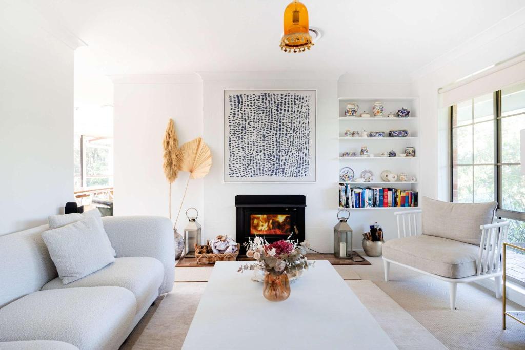 a living room with a couch and a fireplace at Point Break in Bawley Point