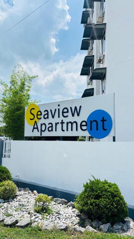 a sign for a savoy apartment building next to a building at Seaview Apartment in Kuah