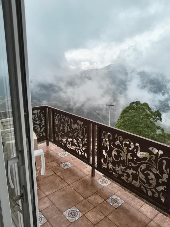 a balcony with a view of the clouds at Kodai Cloud Villa in Kodaikānāl