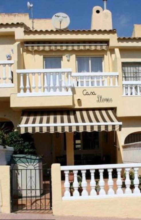 a large building with a sign on the side of it at Casa Flores in El Campello