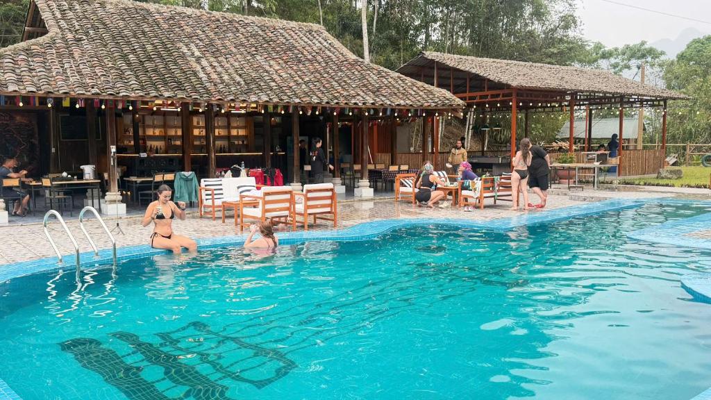a group of people playing in a swimming pool at Loop Tribe Hostel in Ha Giang