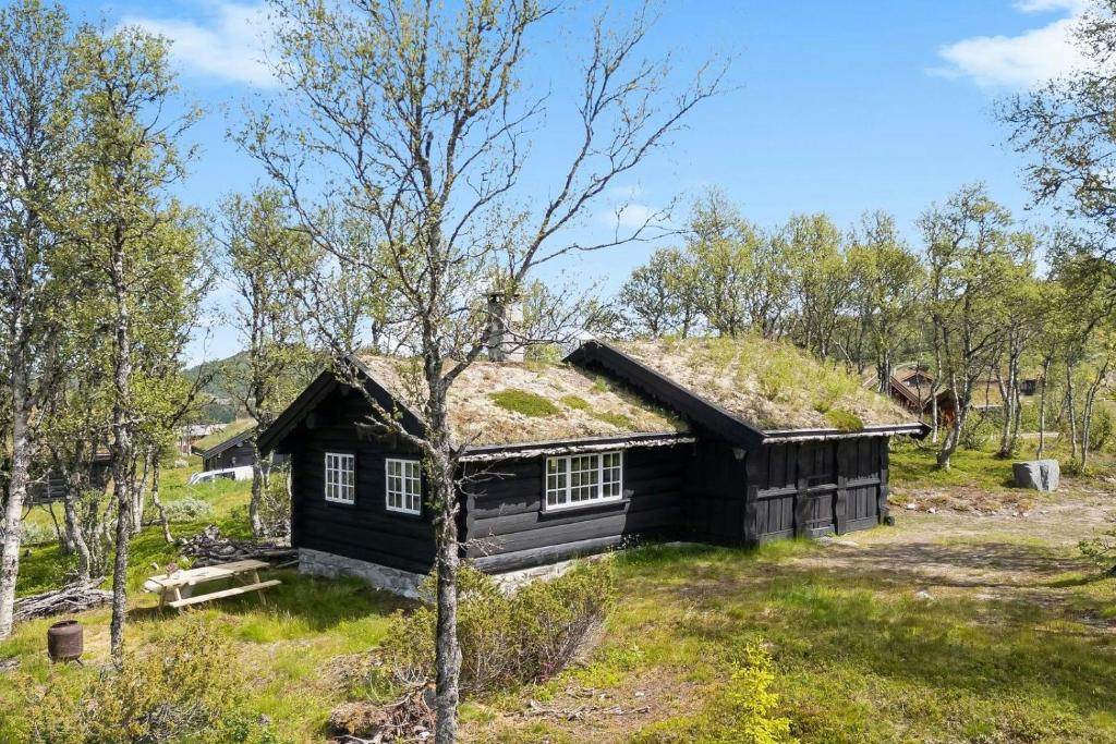a log cabin with a grass roof at Traditional Log Cabin At Vierli in Rauland