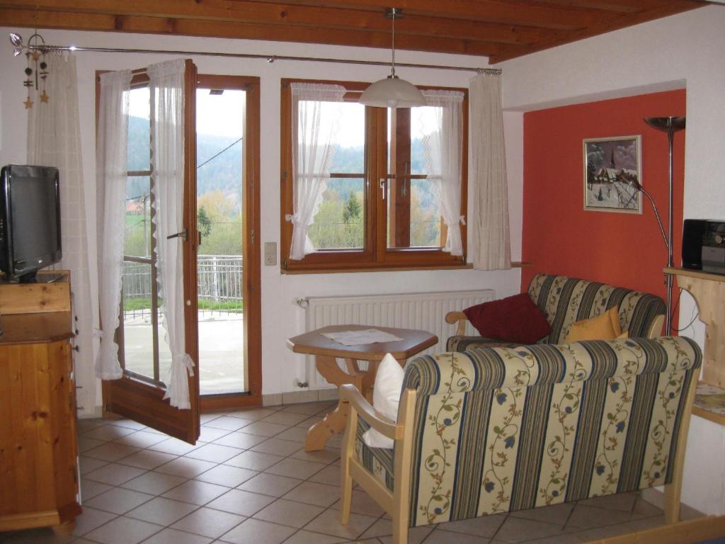 a living room with a couch and a table at Haus am Kreuzbühl in Dachsberg im Schwarzwald