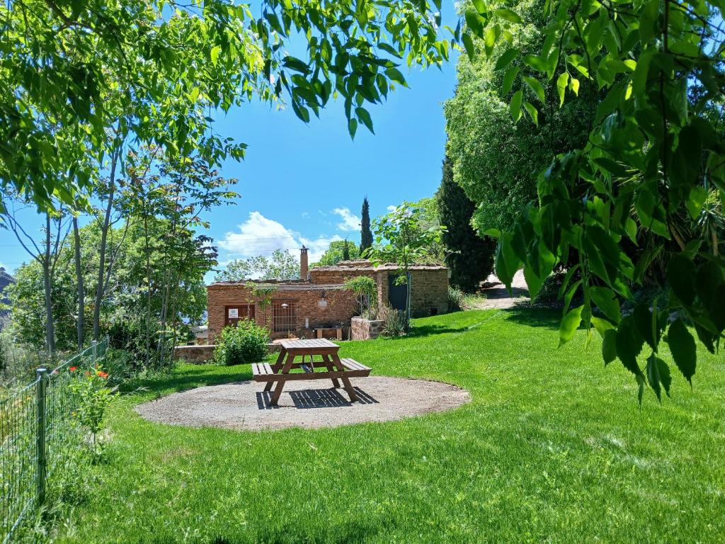 a picnic table in the middle of a garden at Cortijo De Los Abuelos in Pampaneira