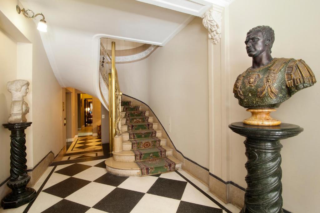 a staircase in a house with a statue of a bust at Leonardo Da Vinci Residence in Buenos Aires