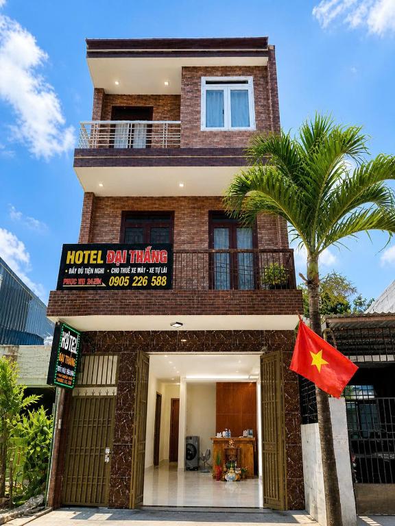a building with a flag in front of it at Đại Thắng Hotel in Danang