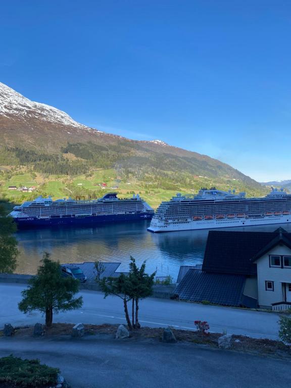 two cruise ships are docked in a river at Charming view in Olden