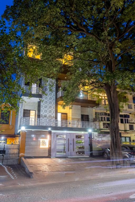 a building with a tree in front of it at SKS Hospitality in Gurgaon
