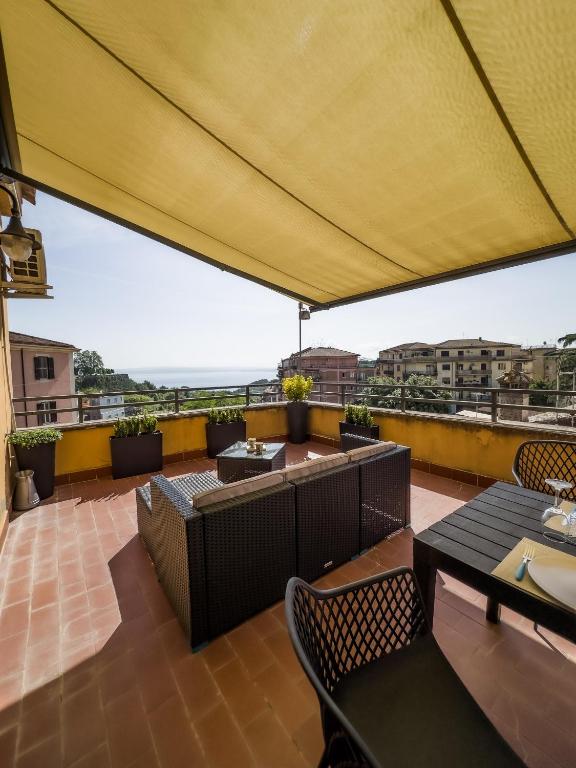 a patio with tables and chairs on a roof at Casa Silvia in Bracciano