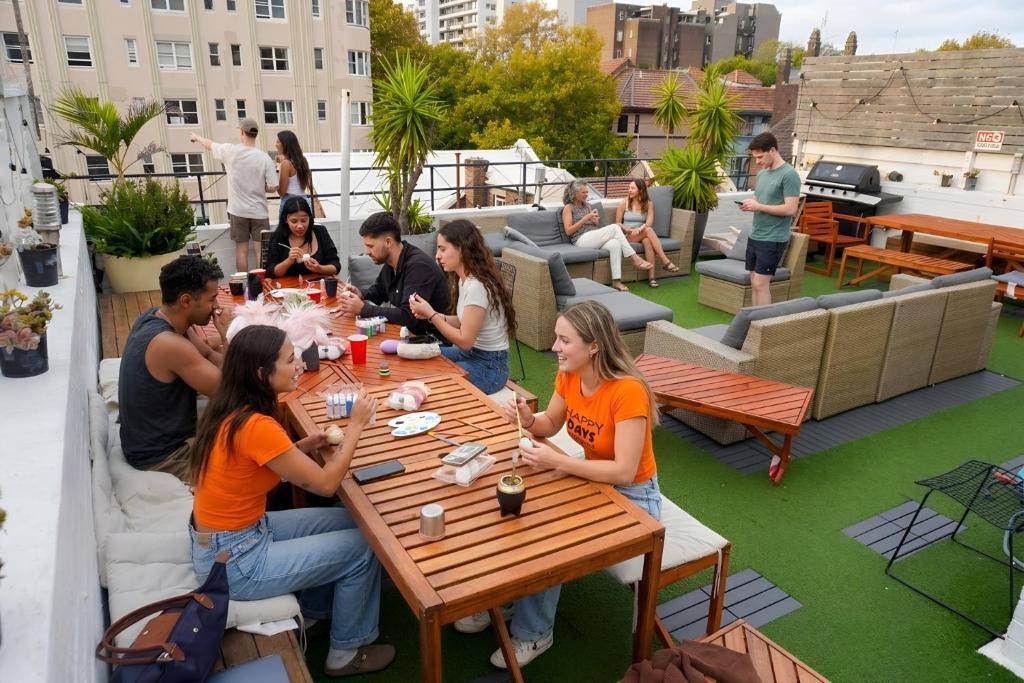 a group of people sitting at a table on a rooftop patio at Tequila Sunrise Potts Point in Sydney