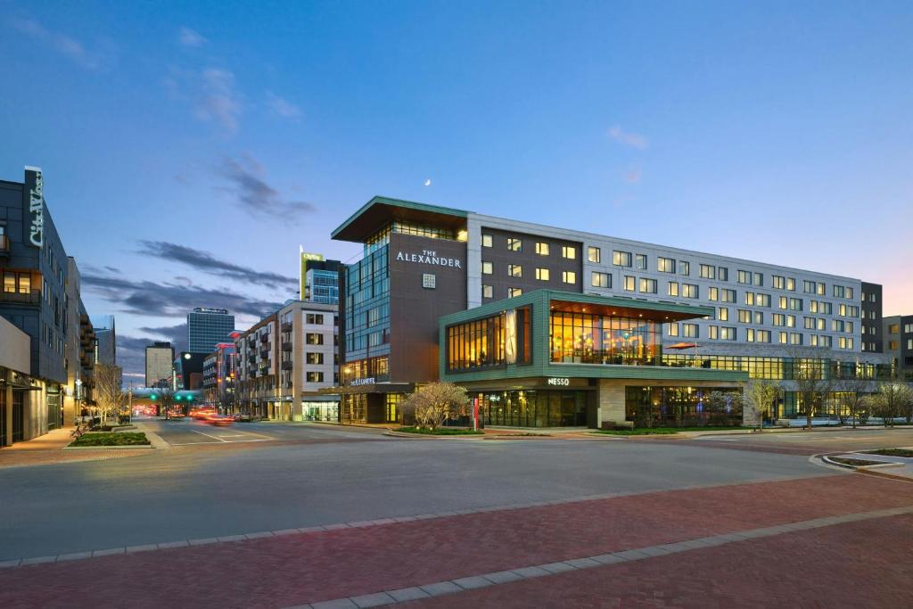 a large building on a street in a city at The Alexander, Autograph Collection in Indianapolis
