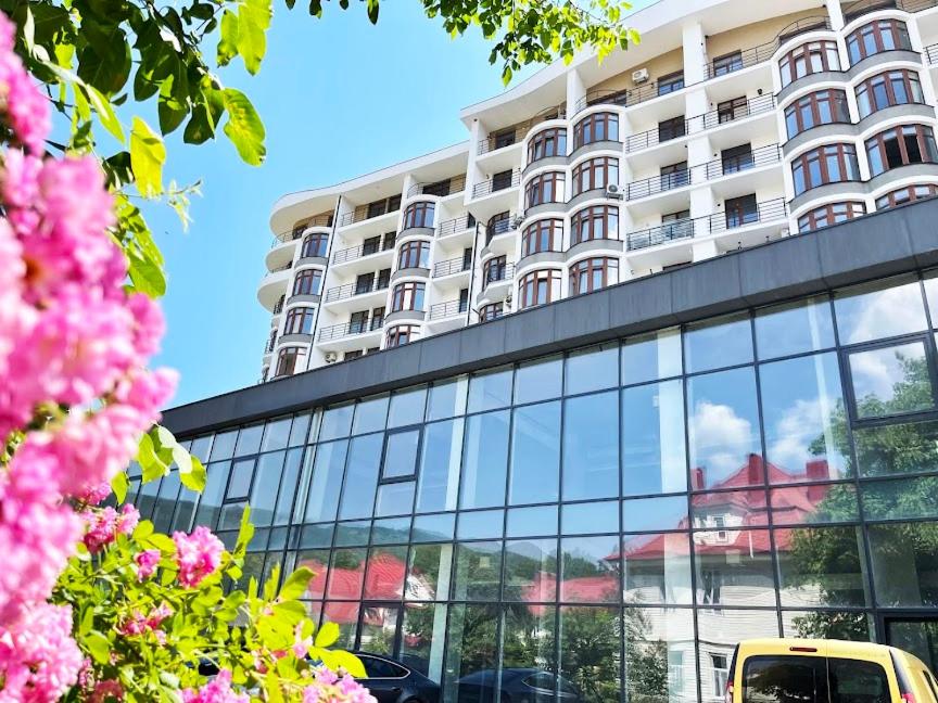 a yellow bus parked in front of a building at Апартаменти ЖК Скеля in Yaremche