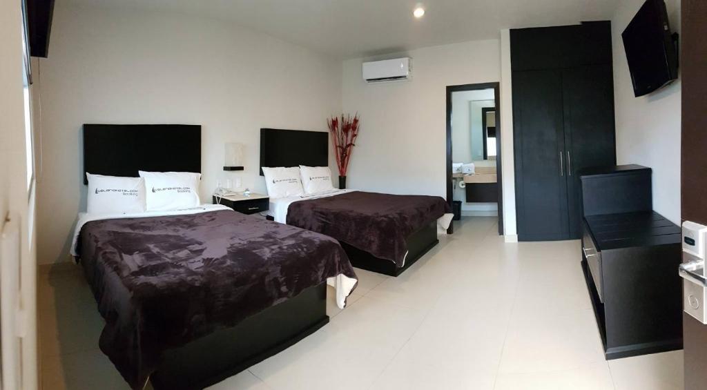 Postel nebo postele na pokoji v ubytování Hotel Velario