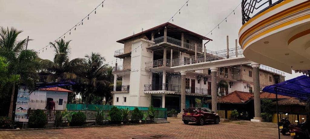 a building with a car parked in front of it at RS Green Barathi in Kilinochchi