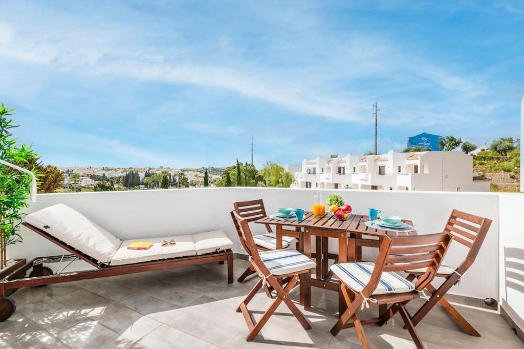 a patio with a table and chairs on a balcony at Clube Albufeira: 2BR Prime Holidays Retreat in Albufeira
