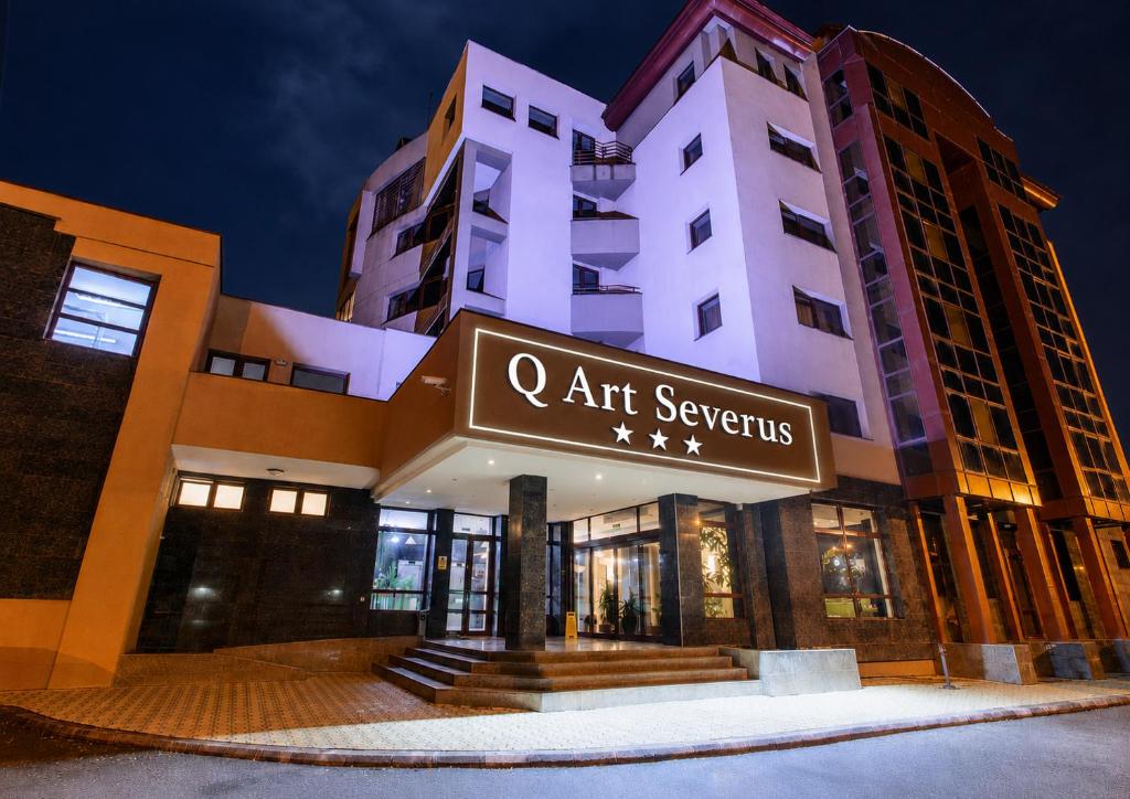 a building with a sign that reads art services at Hotel Q Art Severus in Zalău