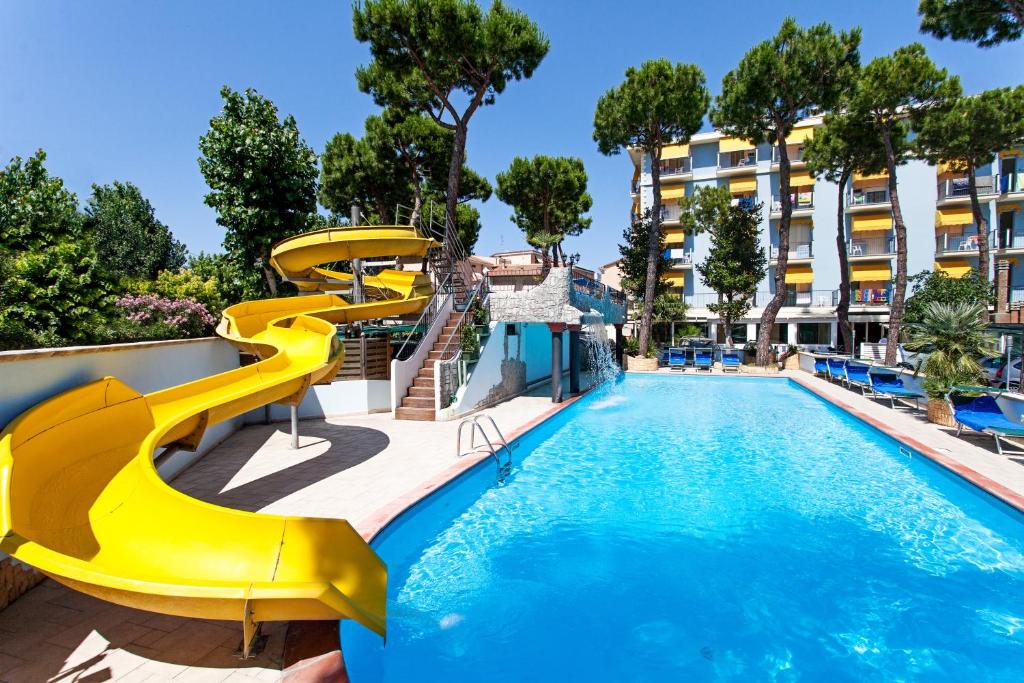 a swimming pool with a water slide in a resort at Hotel Fabrizio in Rimini