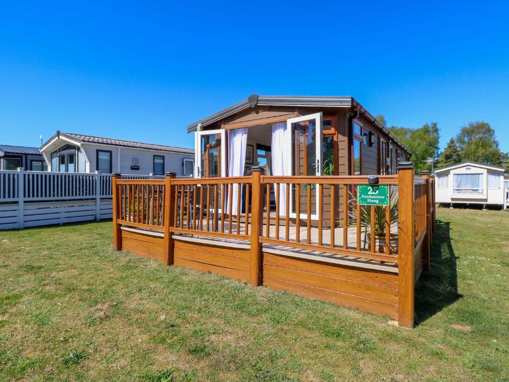 a small house with a wooden deck on a yard at 25 Foxburrow Hang in Great Yarmouth