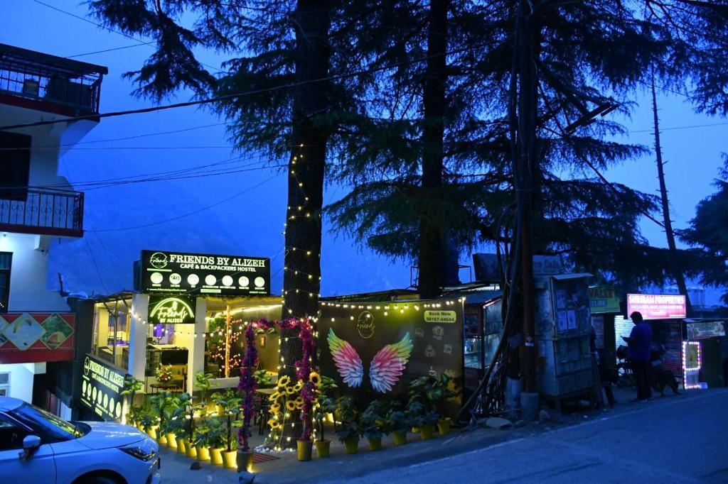 a building decorated with christmas lights on a street at Friends By Alizeh 2 0 Mcleodganj in Dharamshala
