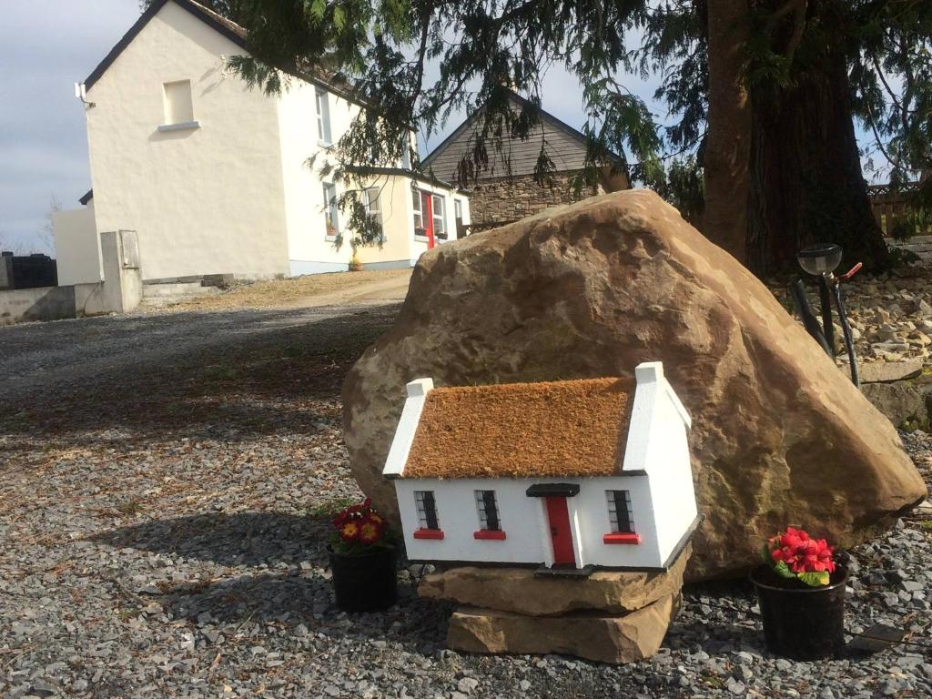 a model house sitting on top of a rock at Douglas Lodge Holiday Homes in Keadew