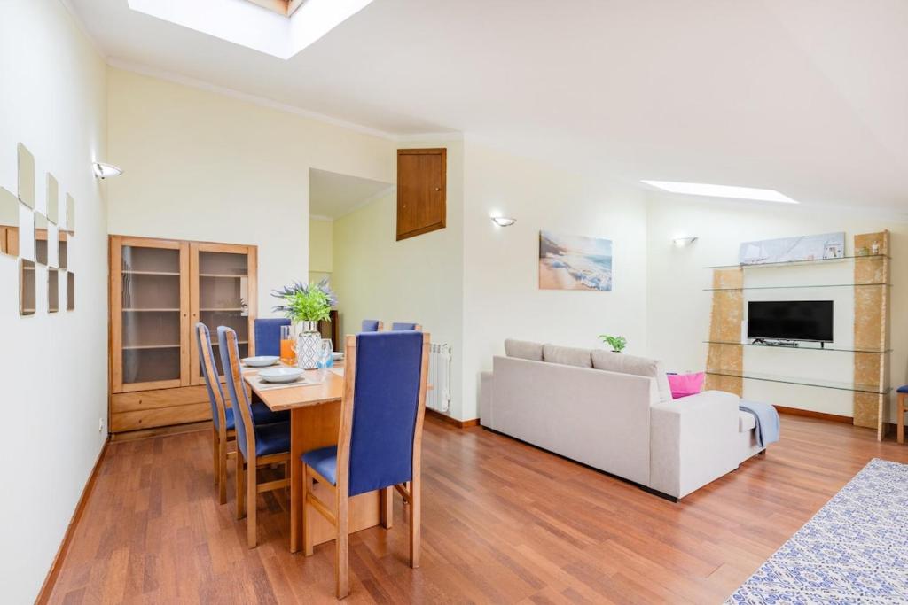 a living room with a table and a couch at Top Floor Retreat in Espinho in Espinho