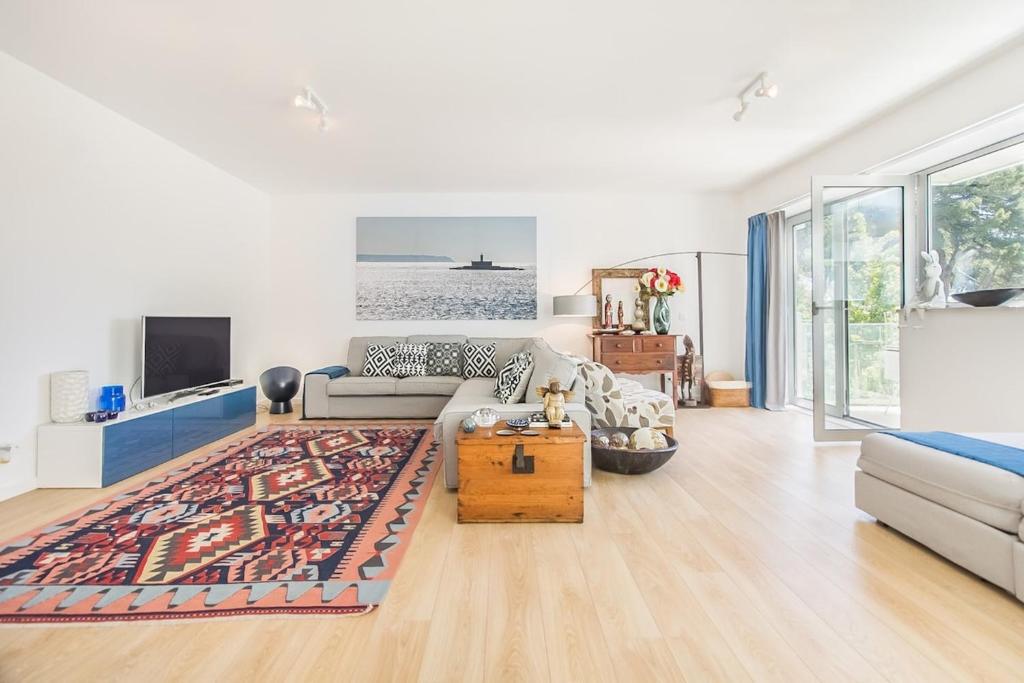 a living room with a couch and a table at Luxury Beach Experience in Lisbon in Oeiras