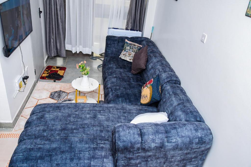 a blue couch sitting in a living room at Royalty homes in Kiambu