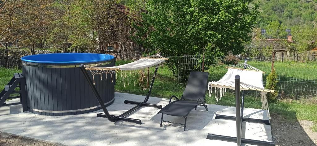 a ping pong table and chairs on a patio at Lotru Relax A-Frame in Malaia