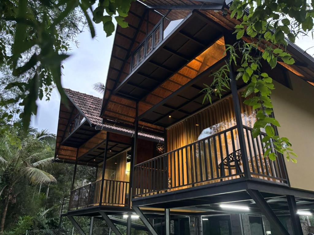 a house with wooden balconies on the side of it at Casa Kabani Resort in Chegāt