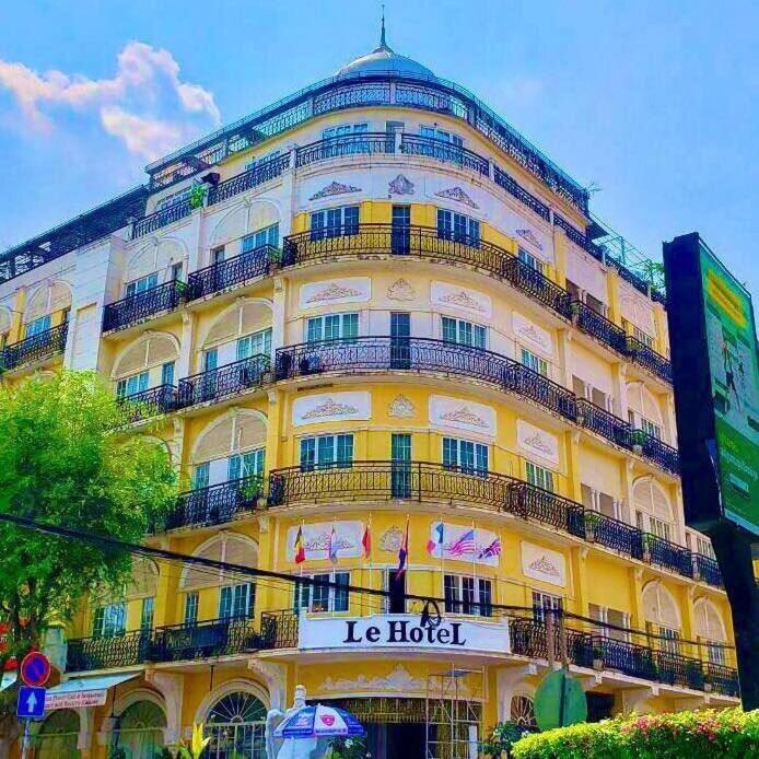 a large yellow building with a hotel sign on it at Le Grand Palais Hotel in Phnom Penh