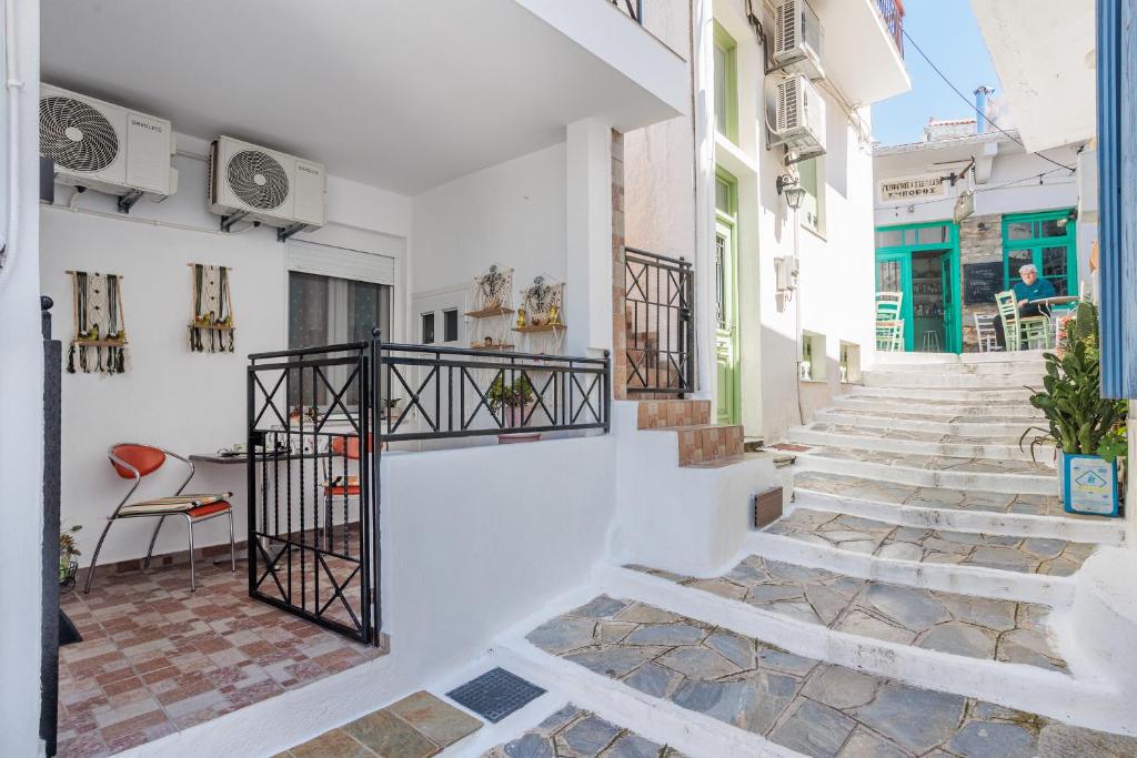 a street with white walls and stairs in a building at Dimitra's House in Glossa