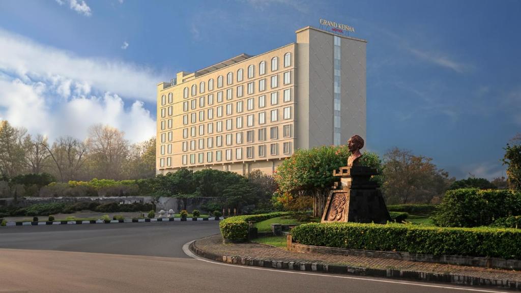 a rendering of a building with a statue in front of it at Grand Keisha Yogyakarta in Yogyakarta