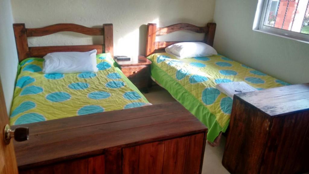 Postel nebo postele na pokoji v ubytování Finca Hotel La Ponderosa