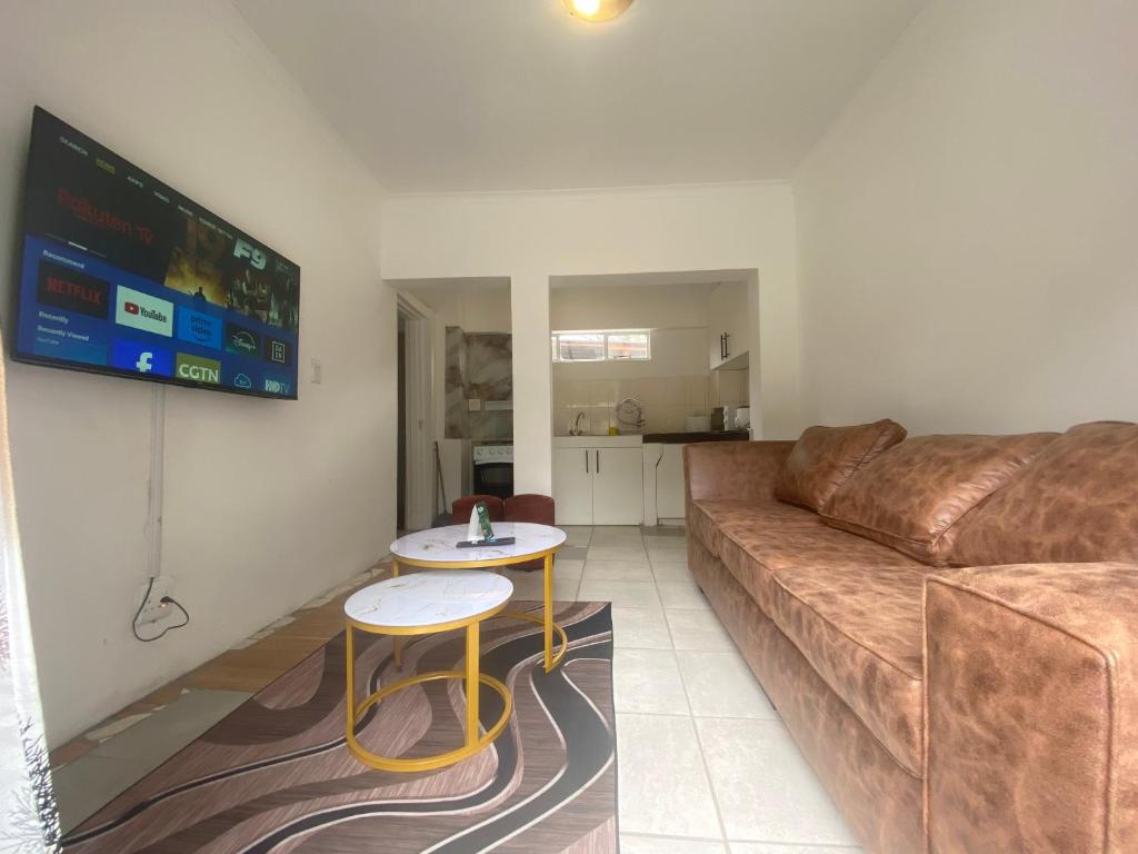 a living room with a couch and a table at Fiet Star in Midrand