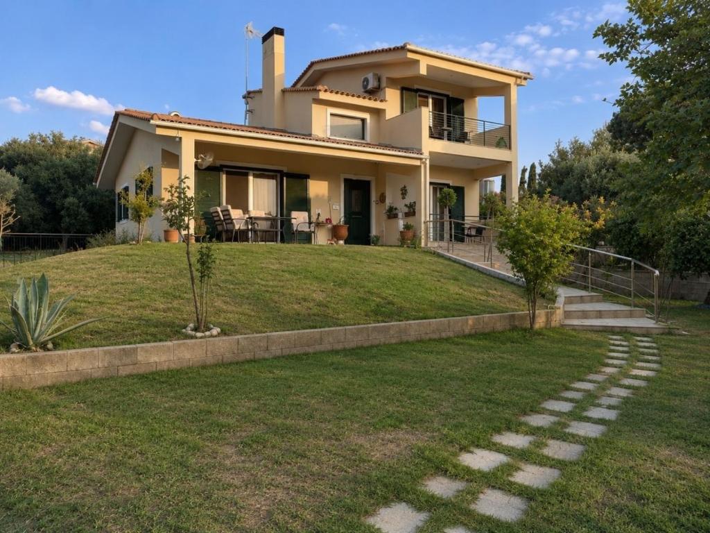 a house with a lawn in front of it at Villa Alexandra Rio Patra in Áyios Vasílios