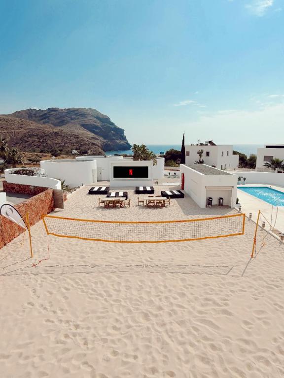 a resort with a sandy beach and a swimming pool at Las Negras Olivencia Natural in Las Negras