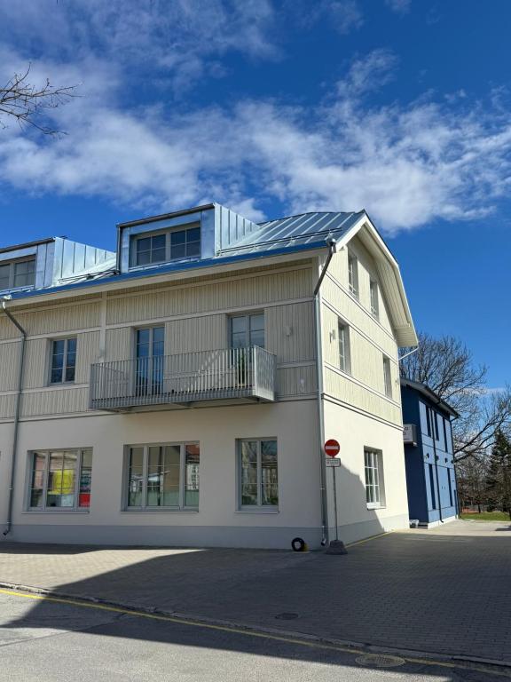 a white building with a balcony on top of it at Lossipargi Loft in Haapsalu