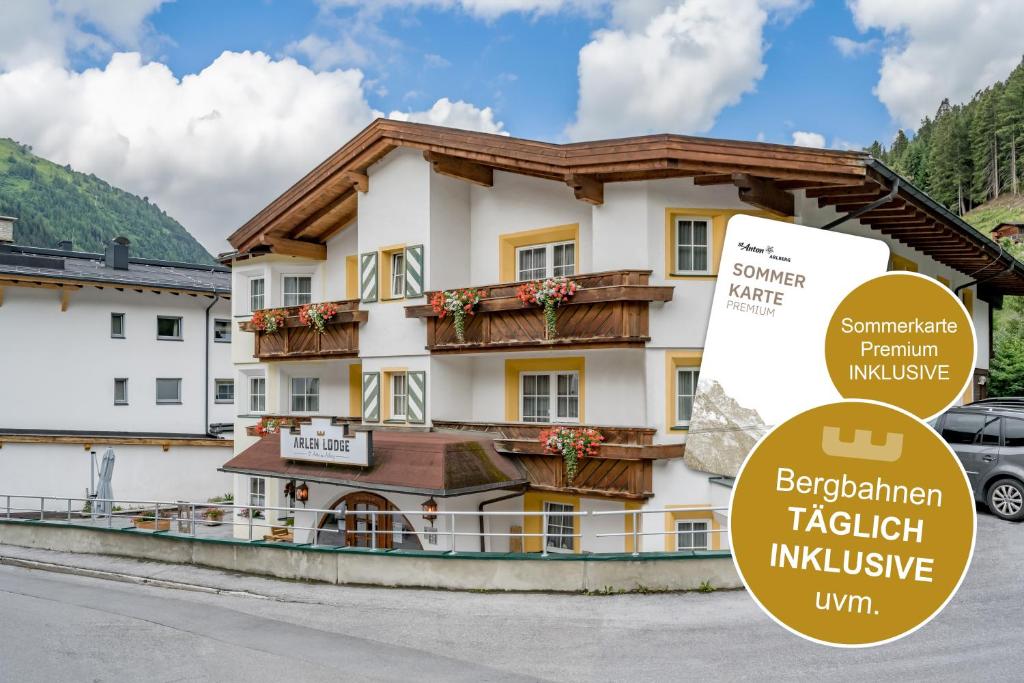 ein Hotel mit einem Schild davor in der Unterkunft Arlen Lodge Hotel-Garni inkl Premium Sommerkarte in Sankt Anton am Arlberg