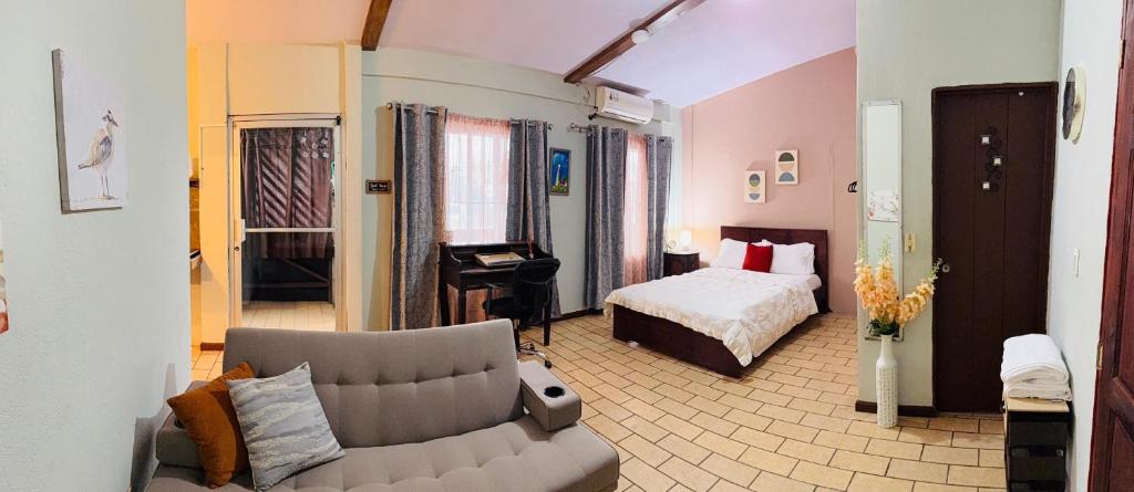 a living room with a couch and a bed at Quepos Prime in Quepos