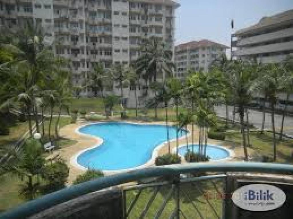 a view of a swimming pool from the balcony of a building at Cocobay Resort Condominium in Port Dickson