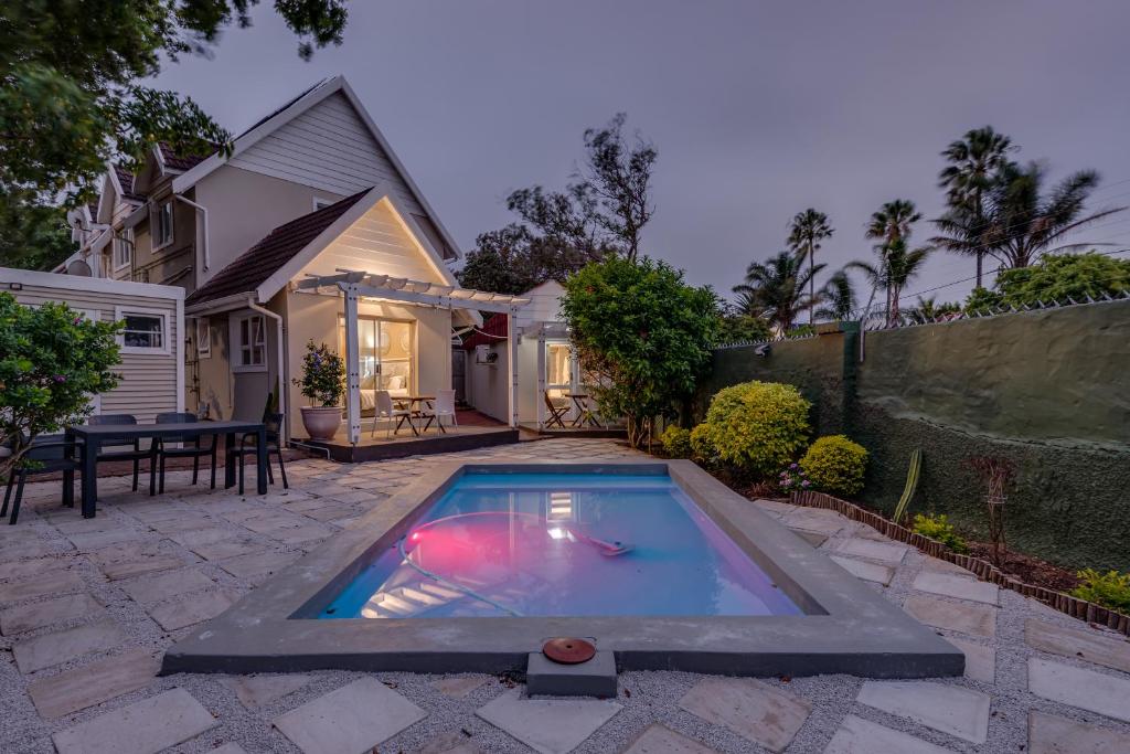 a swimming pool in the backyard of a house at Mill Park Corner Cottages in Port Elizabeth