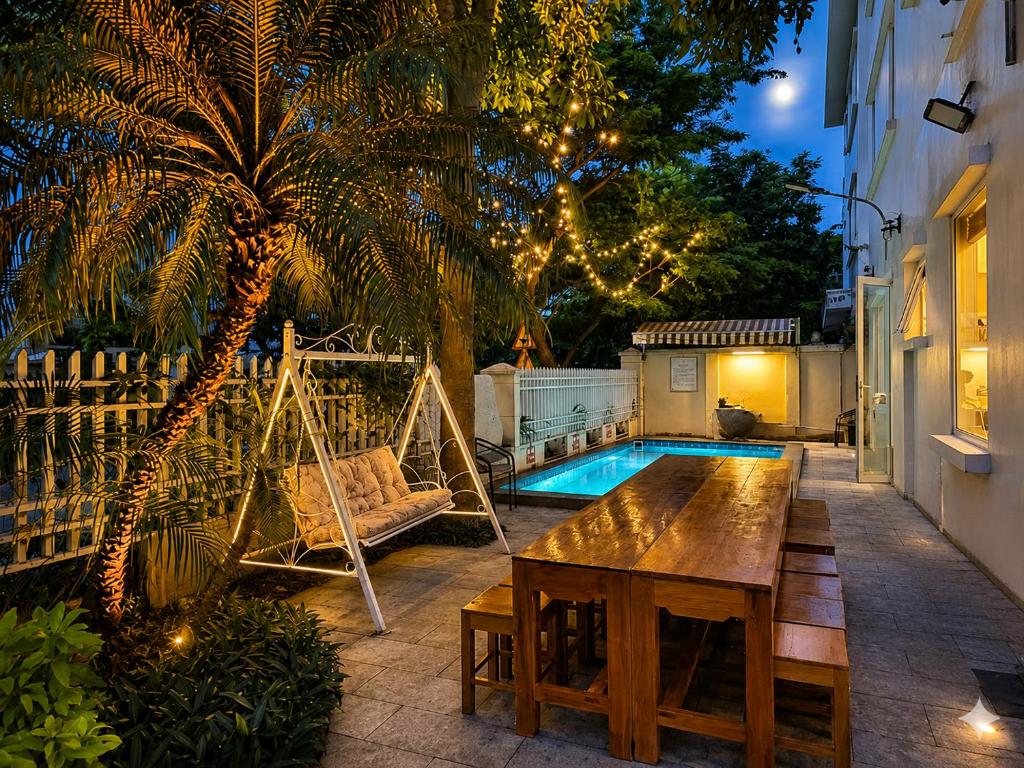 a backyard with a hammock and a swing and a pool at Villa FLC Sầm Sơn SH20 in Sầm Sơn