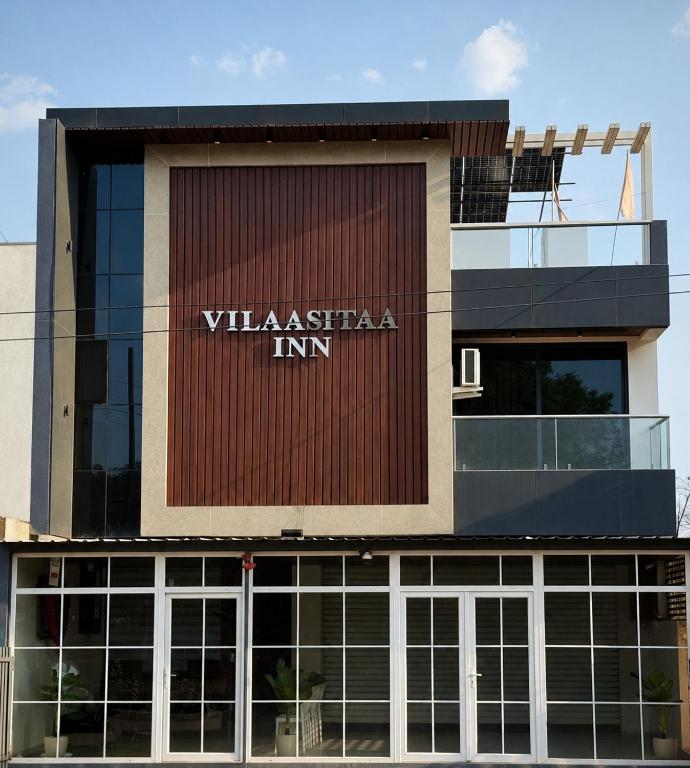 a building with a sign that reads vlasica inn at Hotel Vilaasitaa inn Ujjain in Ujjain